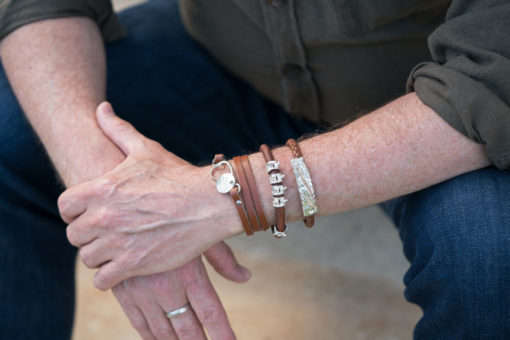 BCH and AIW bracelets on arm