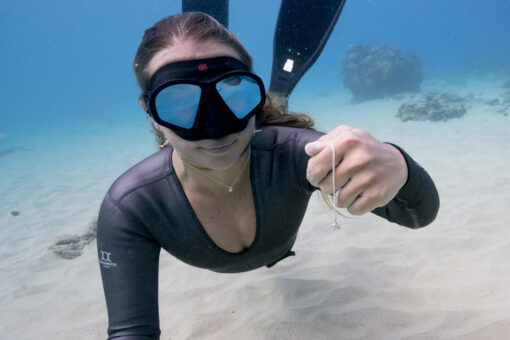 Model and sea star necklace underwater