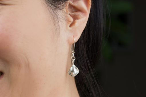 baby stingray earrings on model