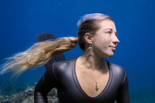 Blue shark necklace and naia earrings on model 2